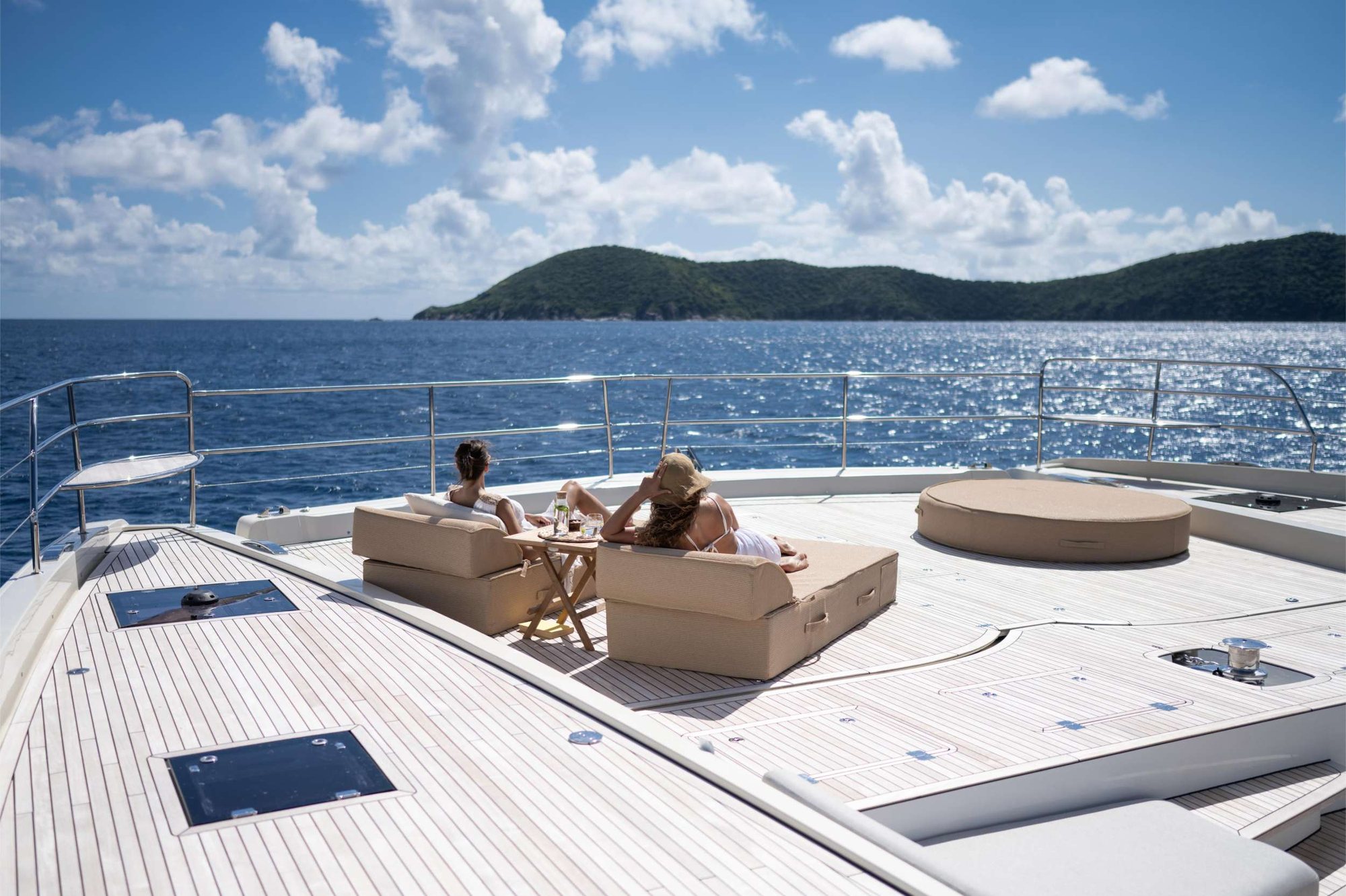 Guests relaxing on the deck of a crewed Charter Caribe catamaran